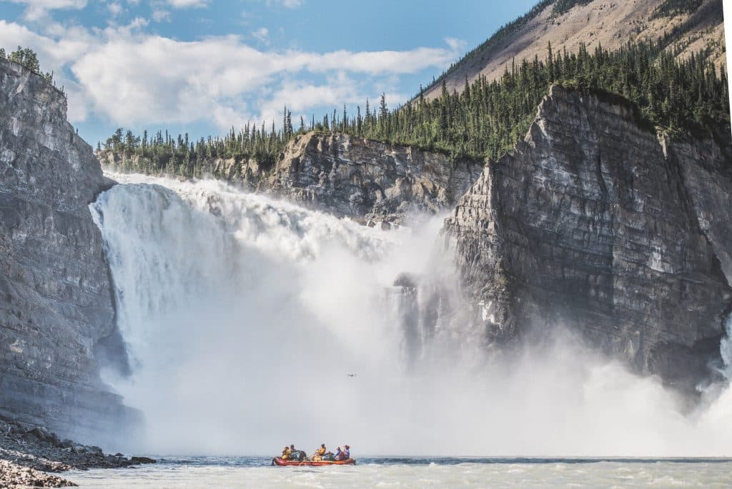 Rafting near a majestic waterfall.