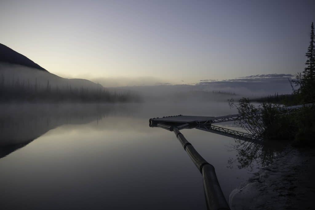 Serene lake at dawn with mist
