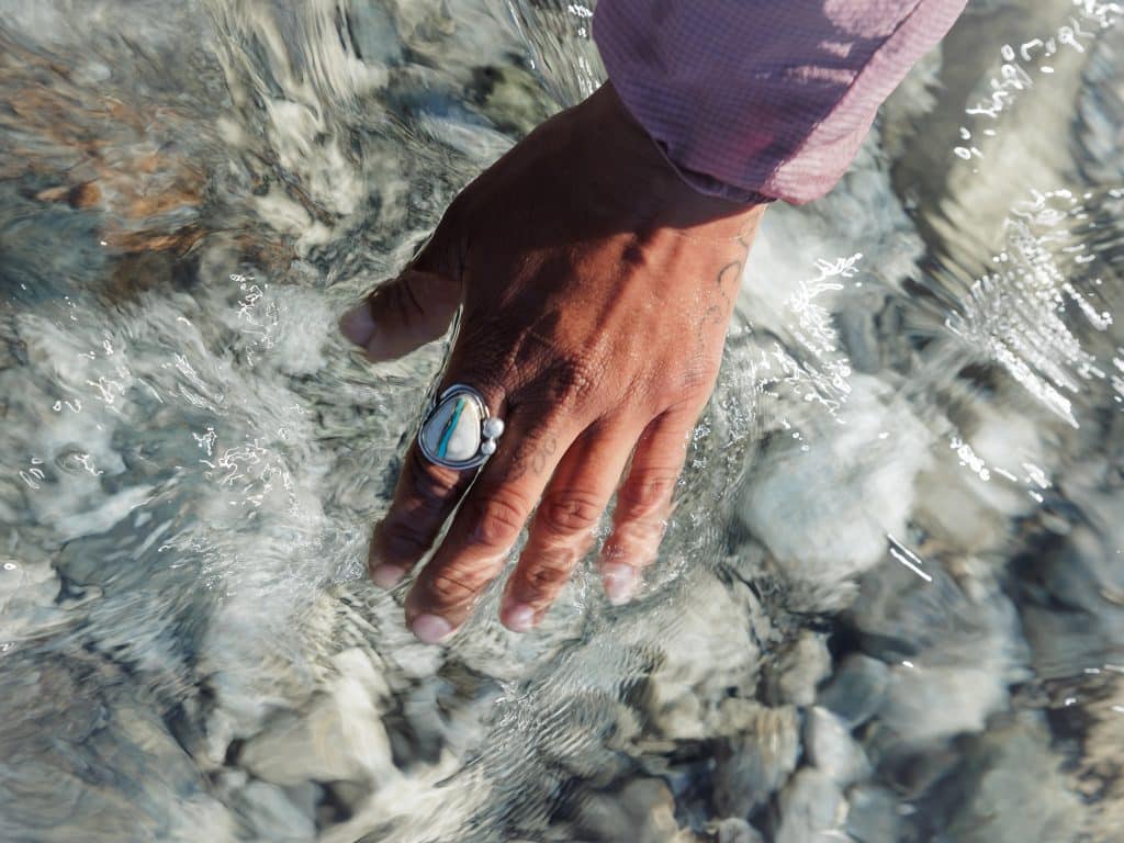 Hand with ring in clear water